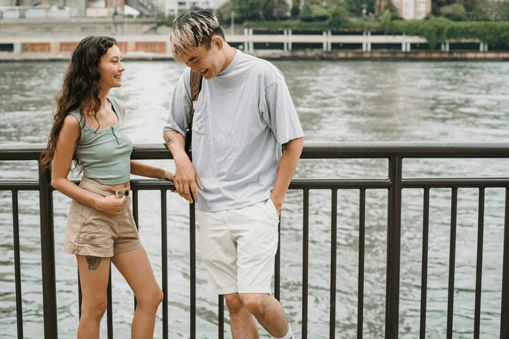 Two friends laughing together outdoors